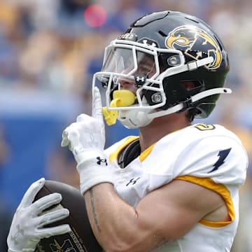 Aug 31, 2024; Pittsburgh, Pennsylvania, USA;  Kent State Golden Flashes wide receiver Luke Floriea (0) gestures to the Pittsburgh Panthers student section after scoring a touchdown during the first quarter at Acrisure Stadium. Mandatory Credit: Charles LeClaire-Imagn Images