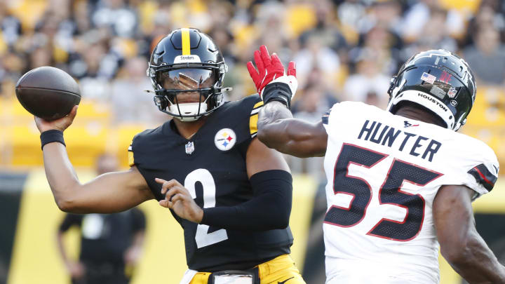 Aug 9, 2024; Pittsburgh, Pennsylvania, USA;  Pittsburgh Steelers quarterback Justin Fields (2) passes against pressure from Houston Texans defensive end Danielle Hunter (55) during the first quarter at Acrisure Stadium. Mandatory Credit: Charles LeClaire-USA TODAY Sports