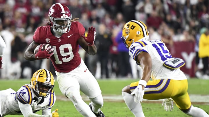 Nov 4, 2023; Tuscaloosa, Alabama, USA;  Alabama Crimson Tide wide receiver Kendrick Law (19) runs against LSU Tigers safety Andre Sam (14) and safety Sage Ryan (15) at Bryant-Denny Stadium. Alabama defeated LSU 42-28. Mandatory Credit: Gary Cosby Jr.-USA TODAY Sports