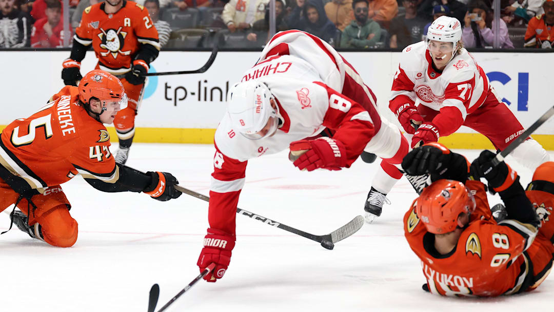 Oct 31, 2025; Anaheim, California, USA;  Anaheim Ducks right wing Beckett Sennecke (45) controls the puck as Detroit Red Wings defenseman Ben Chiarot (8) jumps over the puck during the second period at Honda Center. Mandatory Credit: Kiyoshi Mio-Imagn Images Oct 31, 2025; Anaheim, California, USA;  Anaheim Ducks right wing Beckett Sennecke (45) controls the puck as Detroit Red Wings defenseman Ben Chiarot (8) jumps over the puck during the second period at Honda Center. Mandatory Credit: Kiyoshi Mio-Imagn Images