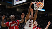Alabama Crimson Tide forward Derrion Reid (35) throws down a dunk between Robert Morris Colonials guard Kam Woods (8) and Robert Morris Colonials forward Alvaro Folgueiras (7) during the second half of an NCAA Tournament First Round game at Rocket Arena on Friday, March 21, 2025, in Cleveland, Ohio.
