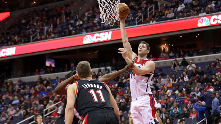 Jan 16, 2017; Washington, DC, USA; Washington Wizards forward Jason Smith (14) shoots the ball over Portland Trail Blazers forward Noah Vonleh (21) and Trail Blazers forward Meyers Leonard (11) in the third quarter at Verizon Center. The Wizards won 120-101. Mandatory Credit: Geoff Burke-Imagn Images