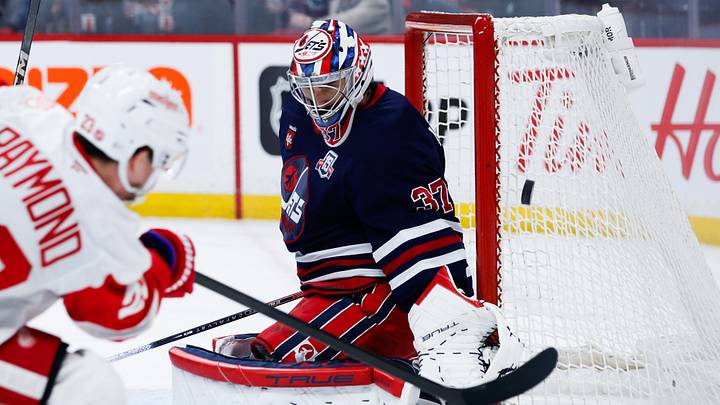 Jan 24, 2026; Winnipeg, Manitoba, CAN; Winnipeg Jets goalie Connor Hellebuyck (37) guards the post on a shot by Detroit Red Wings forward Lucas Raymond (23) during the first period at Canada Life Centre. Mandatory Credit: Terrence Lee-Imagn Images Jan 24, 2026; Winnipeg, Manitoba, CAN; Winnipeg Jets goalie Connor Hellebuyck (37) guards the post on a shot by Detroit Red Wings forward Lucas Raymond (23) during the first period at Canada Life Centre. Mandatory Credit: Terrence Lee-Imagn Images