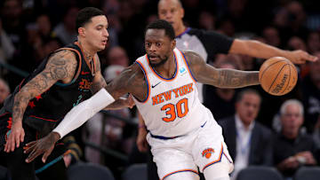 Jan 18, 2024; New York, New York, USA; New York Knicks forward Julius Randle (30) controls the ball against Washington Wizards forward Kyle Kuzma (33) during the third quarter at Madison Square Garden.