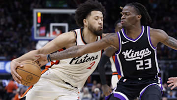 Apr 7, 2025; Detroit, Michigan, USA;  Sacramento Kings guard Keon Ellis (23) knocks the ball away from Detroit Pistons guard Cade Cunningham (2) in the second half at Little Caesars Arena.