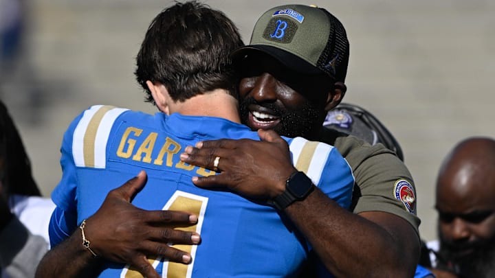 Nov 30, 2024; Pasadena, California, USA; UCLA Bruins head coach DeShaun Foster hugs UCLA Bruins quarterback Ethan Garbers (4) during pregame “senior day” ceremonies before playing the Fresno State Bulldogs at Rose Bowl. Mandatory Credit: Robert Hanashiro-Imagn Images Nov 30, 2024; Pasadena, California, USA; UCLA Bruins head coach DeShaun Foster hugs UCLA Bruins quarterback Ethan Garbers (4) during pregame “senior day” ceremonies before playing the Fresno State Bulldogs at Rose Bowl. Mandatory Credit: Robert Hanashiro-Imagn Images