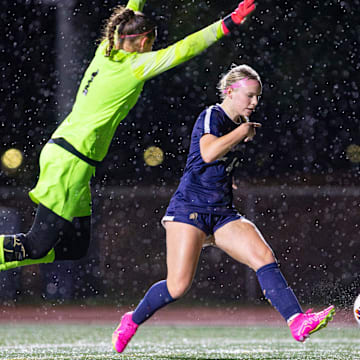 Marist's Libby McLaughlin shoots the ball past La Grande's Lyndie Isaacson.