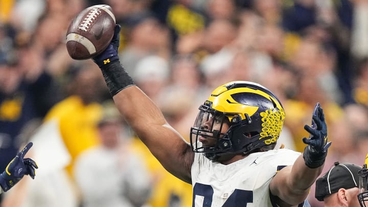 Michigan Wolverines defensive lineman Kris Jenkins (94) celebrates a recovered fumble Saturday, Dec. 2, 2023, during the game at Lucas Oil Stadium in Indianapolis.