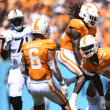 Virginia Cavaliers quarterback Tony Muskett (11) lays on the ground as Volunteers defensive lineman James Pearce Jr. (27) celebrates his sack with teammates during their game at Nissan Stadium Saturday, Sept. 2, 2023.