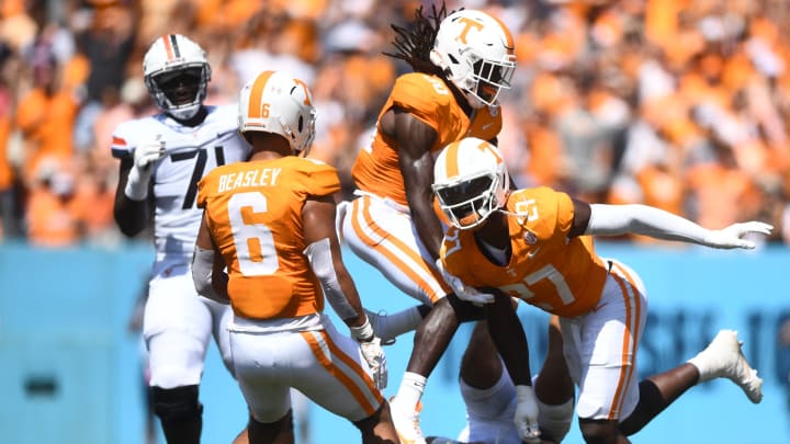 Virginia Cavaliers quarterback Tony Muskett (11) lays on the ground as Volunteers defensive lineman James Pearce Jr. (27) celebrates his sack with teammates during their game at Nissan Stadium Saturday, Sept. 2, 2023.