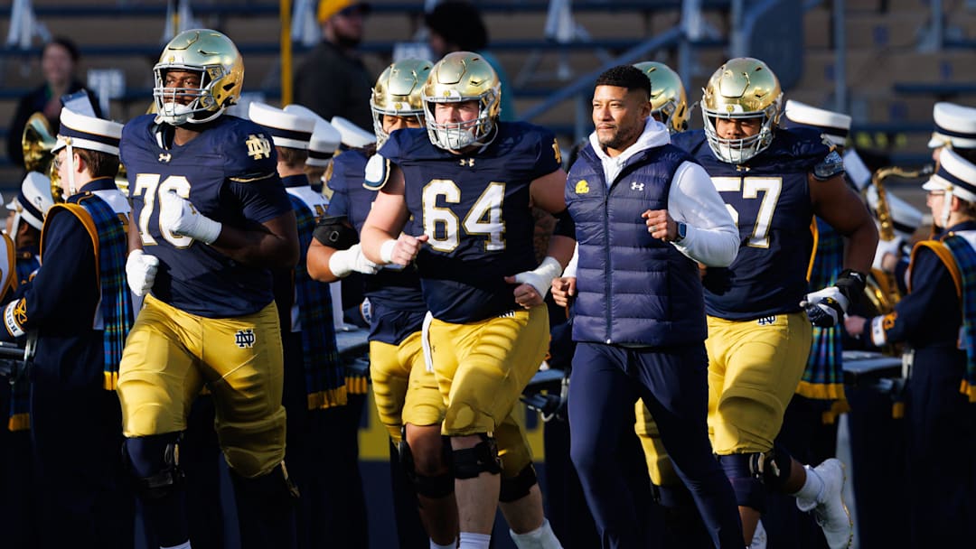 Notre Dame head coach Marcus Freeman takes the field with his players before a NCAA football game against Syracuse at Notre Dame Stadium on Saturday, Nov. 22, 2025, in South Bend.
