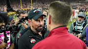Dec 6, 2025; Indianapolis, IN, USA; Ohio State Buckeyes head coach Ryan Day and Indiana Hoosiers head coach Curt Cignetti shake hands after the 2025 Big Ten championship game at Lucas Oil Stadium. Mandatory Credit: Robert Goddin-Imagn Images