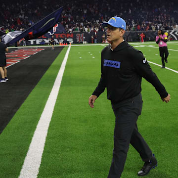 Jan 11, 2025; Houston, Texas, USA; Los Angeles Chargers head coach Jim Harbaugh walks off after losing to Houston Texans in an AFC wild card game at NRG Stadium. Mandatory Credit: Thomas Shea-Imagn Images