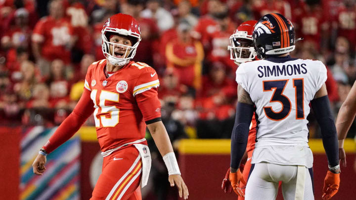 Oct 12, 2023; Kansas City, Missouri, USA; Kansas City Chiefs quarterback Patrick Mahomes (15) speaks to Denver Broncos safety Justin Simmons (31) after a play during the first half at GEHA Field at Arrowhead Stadium. Mandatory Credit: Denny Medley-USA TODAY Sports