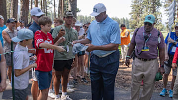 Former NBA star Charles Barkley signs autographs for fans during the American Century Celebrity Championship golf tournament