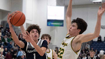 Manasquan Darius Adams puts in a shot as he is guarded by RBC Gioacchino Panzini in first half action. Manasquan vs Red Bank Catholic Boys Basketball in Shore Conference Tournament Semifinals in Toms River NJ on February 24, 2022.

Bbsqrc220224a