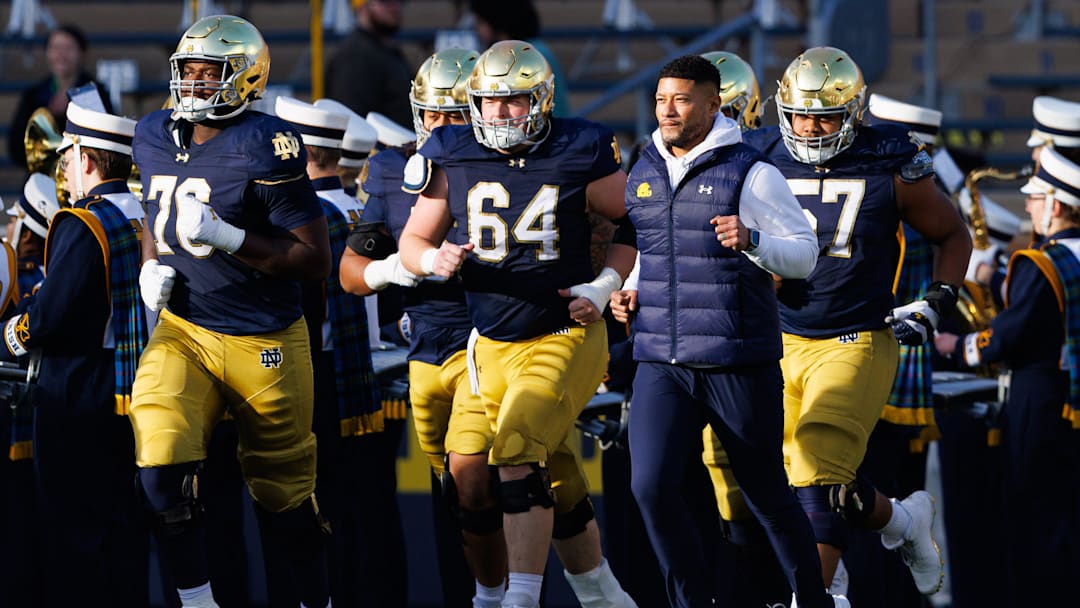 Notre Dame head coach Marcus Freeman takes the field with his players before a NCAA football game against Syracuse at Notre Dame Stadium on Saturday, Nov. 22, 2025, in South Bend.