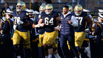 Notre Dame head coach Marcus Freeman takes the field with his players before a NCAA football game against Syracuse at Notre Dame Stadium on Saturday, Nov. 22, 2025, in South Bend.