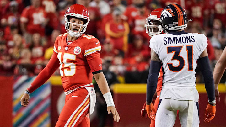 Oct 12, 2023; Kansas City, Missouri, USA; Kansas City Chiefs quarterback Patrick Mahomes (15) speaks to Denver Broncos safety Justin Simmons (31) after a play during the first half at GEHA Field at Arrowhead Stadium. Mandatory Credit: Denny Medley-Imagn Images