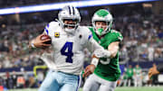Dallas Cowboys quarterback Dak Prescott (4) runs with the ball in attempt to score a touchdown in the fourth quarter against the Philadelphia Eagles at AT&T Stadium.