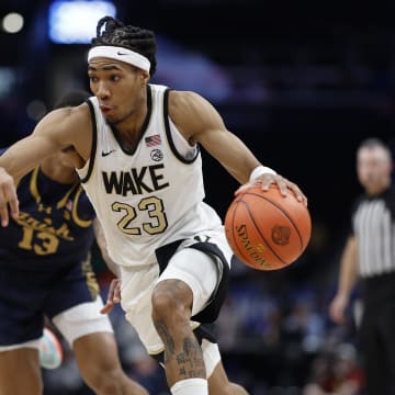 Mar 13, 2024; Washington, D.C., USA; Wake Forest Demon Deacons guard Hunter Sallis (23) drives to the basket past Notre Dame Fighting Irish forward Tae Davis (13) in the second half at Capital One Arena. Mandatory Credit: Geoff Burke-USA TODAY Sports