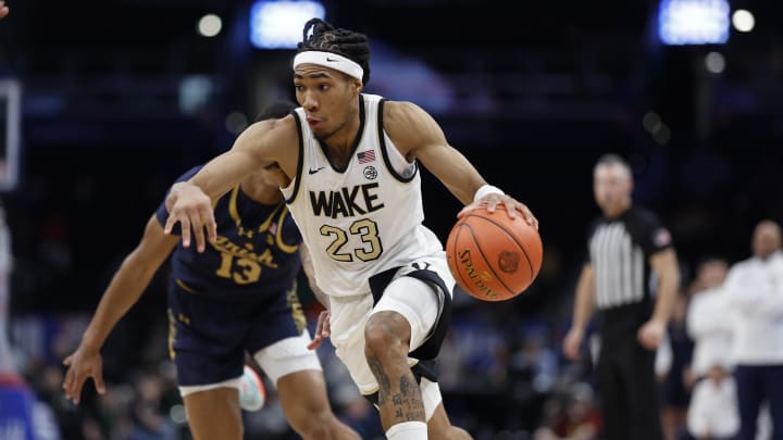 Mar 13, 2024; Washington, D.C., USA; Wake Forest Demon Deacons guard Hunter Sallis (23) drives to the basket past Notre Dame Fighting Irish forward Tae Davis (13) in the second half at Capital One Arena. Mandatory Credit: Geoff Burke-USA TODAY Sports