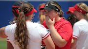 Utah's Paige Parker talks with Mariah Lopez during a softball game between Utah and Washington in the Women's College World Series at USA Softball Hall of Fame Stadium in Oklahoma City, Friday, June 2, 2023. Washington won 4-1.