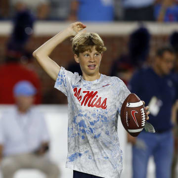 Oct 28, 2023; Oxford, Mississippi, USA; Mississippi Rebels head coach Lane Kiffin (left) and his son Knox Kiffin during warm ups prior to a game against the Vanderbilt Commodores at Vaught-Hemingway Stadium. Mandatory Credit: Petre Thomas-USA TODAY Sports