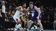 Nov 28, 2025; Charlotte, North Carolina, USA; Chicago Bulls guard Tre Jones (30) looks to pass against Charlotte Hornets guard Koa Knueppel (7) during the first half at the Spectrum Center. Mandatory Credit: Sam Sharpe-Imagn Images