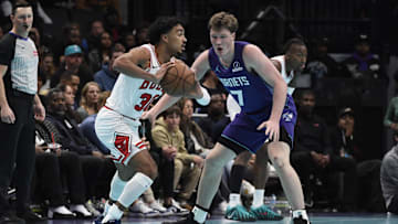 Nov 28, 2025; Charlotte, North Carolina, USA; Chicago Bulls guard Tre Jones (30) looks to pass against Charlotte Hornets guard Koa Knueppel (7) during the first half at the Spectrum Center. Mandatory Credit: Sam Sharpe-Imagn Images