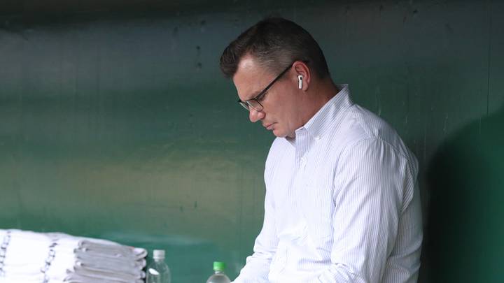 Apr 29, 2025; Pittsburgh, Pennsylvania, USA; Pittsburgh Pirates general manager Ben Cherington checks his phone in he dugout before the game against the Chicago Cubs at PNC Park. Mandatory Credit: Charles LeClaire-Imagn Images
