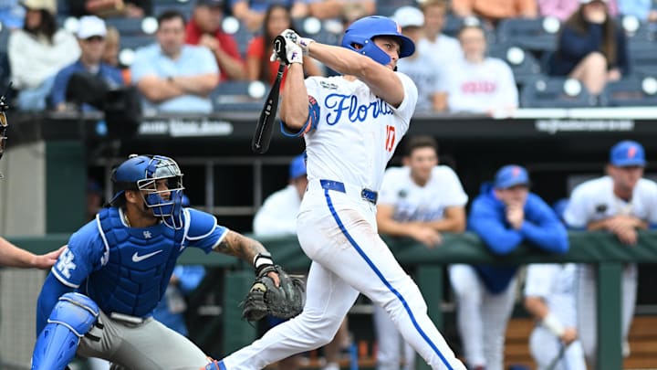 Jun 19, 2024; Omaha, NE, USA;  Florida Gators shortstop Colby Shelton (10) doubles in a run against the Kentucky Wildcats during the first inning at Charles Schwab Field Omaha. Mandatory Credit: Steven Branscombe-Imagn Images