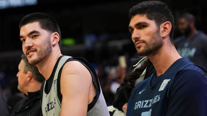 Grizzlies' Zach Edey (14) and Santi Aldama (7) sit on the bench during open practice at the FedExForum on October 4, 2025, in Memphis, Tenn.