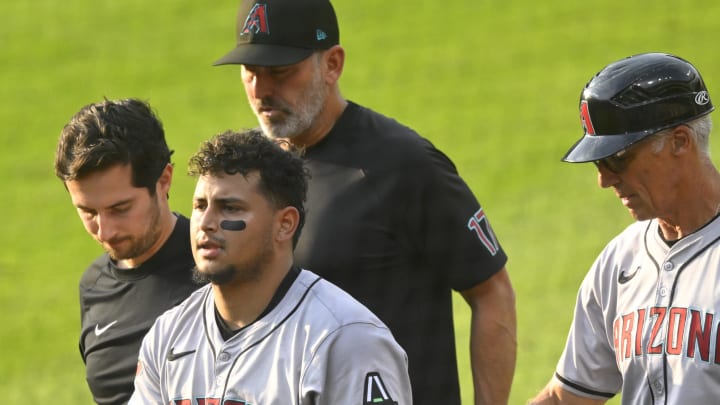 Aug 5, 2024; Cleveland, Ohio, USA; Arizona Diamondbacks catcher Gabriel Moreno (14) walks to the dugout with an apparent injury in the second inning against the Cleveland Guardians at Progressive Field. Mandatory Credit: David Richard-USA TODAY Sports