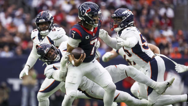 Denver Broncos linebacker Jonathon Cooper (0) and linebacker Baron Browning (56) attempt to tackle C.J. Stroud .