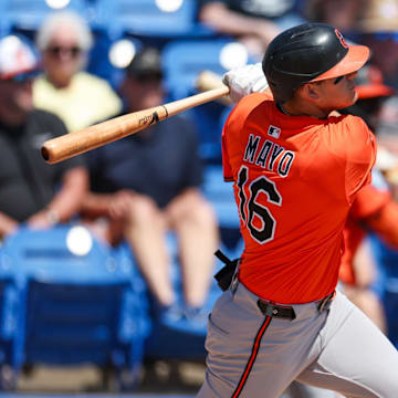 Mar 13, 2025; Dunedin, Florida, USA; Baltimore Orioles third baseman Coby Mayo (16) doubles against the Toronto Blue Jays in the second inning during spring training at TD Ballpark. 
