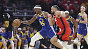 Golden State Warriors forward Jimmy Butler III controls the ball as Houston Rockets forward Dillon Brooks defends.