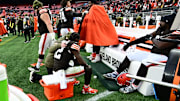Shedeur Sanders (is consoled by a Browns staffer during a blowout loss.