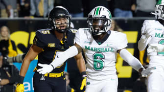 Marshall Thundering Herd defensive back Micah Abraham (6) celebrates a stop as Appalachian State Mountaineers wide receiver Thomas Hennigan (5) looks on during the second quarter at Kidd Brewer Stadium.