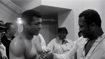 Sep 13, 1978; New Orleans, LA, USA; FILE PHOTO; Muhammad Ali (left) shares a laugh with Joe Frazier