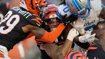 Cincinnati Bengals cornerback Cam Taylor-Britt (29), left, Bengals linebacker Logan Wilson (55) and Bengals safety Geno Stone (22) try to take down Detroit Lions running back Jahmyr Gibbs (0) in the 3rd quarter at Paycor Stadium on October 5, 2025. The Bengals lost 24-37.