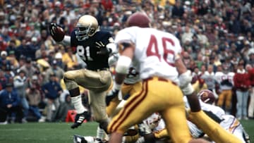Oct 24, 1987, South Bend, IN, USA; FILE PHOTO; Notre Dame Fighting Irish receiver Tim Brown (81) returns a punt against the Southern California Trojans at Notre Dame Stadium during the 1987 season. Mandatory Credit: Malcolm Emmons-Imagn Images