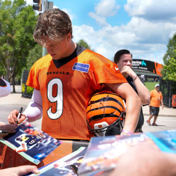 Bengals quarterback Joe Burrow signs autographs after OTAs Tuesday, May 28, 2024 at the Kettering Health Practice Fields outside of Paycor Stadium. Burrow along with several other Bengals players signed jerseys, footballs and other items for fans as they waited for the players to exit the practice field.