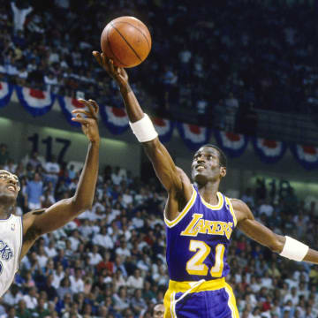 May 1988; Dallas, TX, USA; FILE PHOTO;  Los Angeles Lakers forward Michael Cooper (21) shoots over Dallas Mavericks forward Roy Tarpley (42) during the 1988 NBA Western Conference Finals at Reunion Arena. Mandatory Credit: MPS-USA TODAY Sports