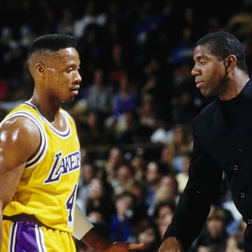 Unknown date; Los Angeles, CA, USA; FILE PHOTO; Los Angeles Lakers guard Magic Johnson (right) slaps hands with Byron Scott (4) during the 1991-92 season at The Forum. Mandatory Credit: MPS-Imagn Images