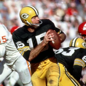 Jan 15, 1987; Los Angeles, CA; USA; Green Bay Packers quarterback (15) Bart Starr in action during Super Bowl I at the Los Angeles Coliseum against the Kansas City Chiefs. The Packers defeated the Chiefs 35-10 to win the first Super Bowl Title. Starr was 16-23 for 250 yards and 2 touchdowns and was named the games most valuable player.  