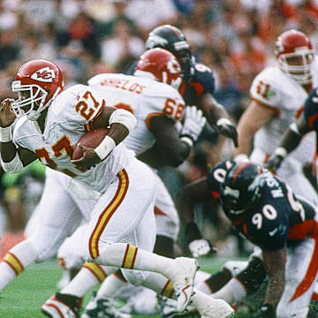 Denver Broncos linebacker Allen Aldridge (No. 57) pursues Kansas City running back Greg Hill during a 1997 game at Mile High Stadium.