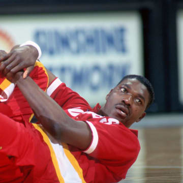 Apr 8, 1990; Orlando, FL, USA; FILE PHOTO; Houston Rockets center #34 HAKEEM OLAJUWON stretches before his game against the Orlando Magic at the Orlando Arena. Mandatory Credit: Photo By USA TODAY Sports (c) Copyright USA TODAY Sports