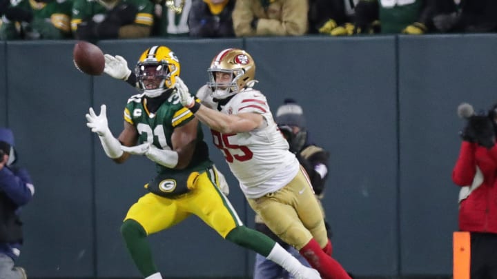 Green Bay Packers safety Adrian Amos (31) intercepts a pass intended for San Francisco 49ers tight end George Kittle (85) during the first half of the divisional playoff game at Lambeau Field in Green Bay on Saturday, Jan. 22, 2022.