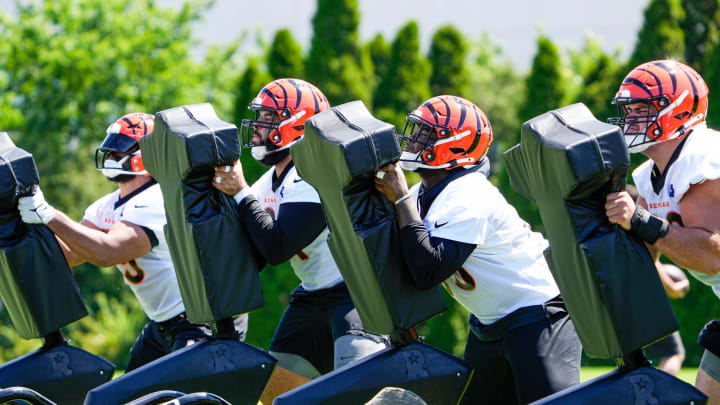 Members of the Bengals offensive line use a tackle sled during OTAs on Tuesday, May 28, 2024, at the Kettering Health Practice Fields outside of Paycor Stadium.